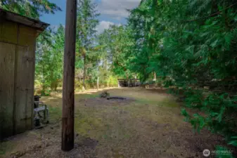 Northwest corner of property with henhouse, firepit area and well head