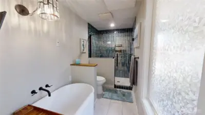 Newly updated primary bath with walk-in shower and soaking tub.
