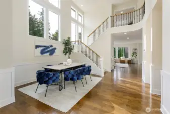 Dramatic entry way, double story ceiling dining room with wall of windows.