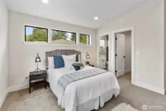 This bedroom features an attached bathroom for added convenience, creating a seamless blend of comfort and functionality.
