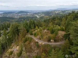 A view looking North showcasing the private drive winding up in elevation accessing the build site.
