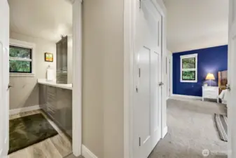 Upstairs hallway showing the main bathroom and the entrance to the primary bedrrom.