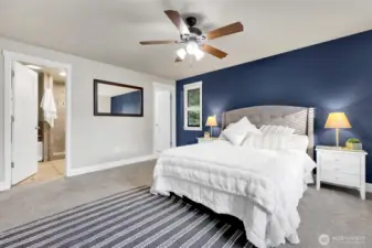 Primary bedroom with the walk-in closet to the right and the ensuite on the right.