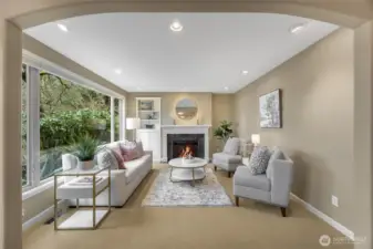 Front living room, just a step sunken and so very pretty. Big windows let in the light and the mature landscaping provides privacy