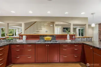 Look at all those drawers! Anyone who is serious about cooking knows that drawers are far superior to shelves. The gas stove has a down draft and the red backsplash slides open to reveal hidden storage.