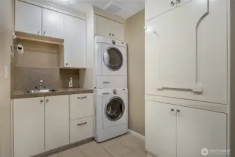 The laundry room off the main floor 3/4 bathroom/ The cabinet opens up to become a folding or craft table.