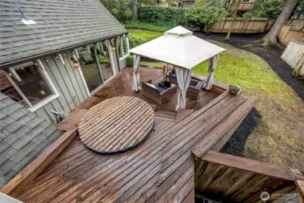 The back deck is multilevel with an old hot tub. Seller has no knowledge of whether or not it works.