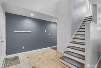 As you enter, you will find a dramatic 2-story entry, beautiful flooring, staircase going up, and family room on your right.