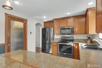 Kitchen view 2 from dining, love the breakfast bar, arched doorways and large pantry to your left!