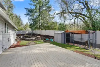 View of your back yard, fully-fenced with new $20K vinyl fencing, HUGE deck, and the new septic system is going in!