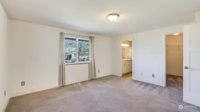 Another angle of the primary capturing the layout of the room. You'll also get to enjoy the wide trim work and solid core doors.