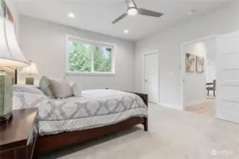 Primary bedroom has wall to wall carpet.