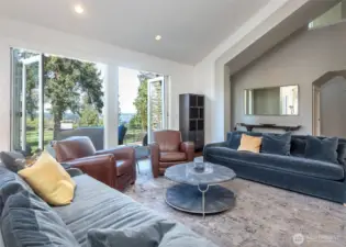 Enjoy seamless indoor/outdoor living with Marvin Ultimate Clad stacking doors, opening wide to connect the main living space with the front patio and stunning fairway views.