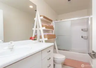 The lower level includes a full bathroom—one of two located on this floor, offering added convenience and flexibility for guests or extended living.the lower level.