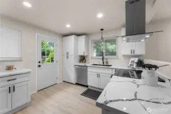 Bright kitchen leads to patio and yard