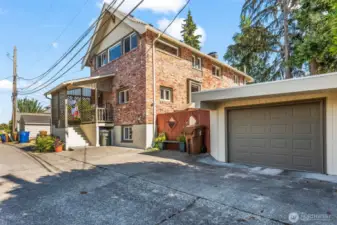 Your carport has an electric garage door and sits off the paved alley.  There is space to park another vehicle back here as well.