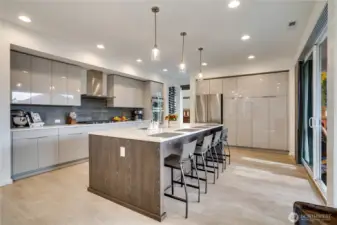 Stunning show-stopping kitchen-quartz island fit for a dinner party, pendants that look hand-blown, and cabinet faces so perfectly lacquered you could see your dreams reflected in them.