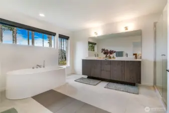 Luxury primary en-suite: spa-like with dual vanities, oversized walk-in shower and deep soaking tub.