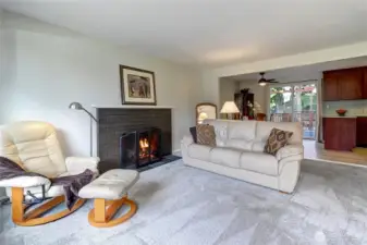 Cozy wood-burning fireplace in upper level living room. Hardwood flooring throughout beneath all carpeting.