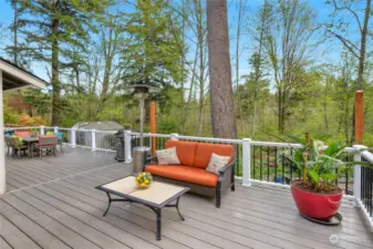The large composite deck flows across the entire back of the home and is a great spot for entertaining!  Lots of privacy behind the home into a native growth protected area and pond.