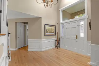 Large entry with hardwood floors and vaulted ceilings.