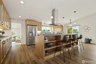 The kitchen is a chef's dream, with ample storage and counter space, attractive appliances and custom red birch cabinetry.