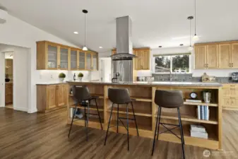 A counter spot for a quick meal or snack,  or for your guests to sit/stand and visit with you while you cook.  Built in shelving/book case below makes brilliant use of the space