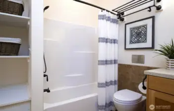 Shower over tub, and a Toto toilet with great storage - what's not to love?