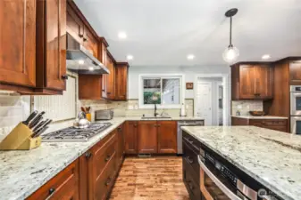 Expansive kitchen with endless storage, granite counters and designer light fixtures.