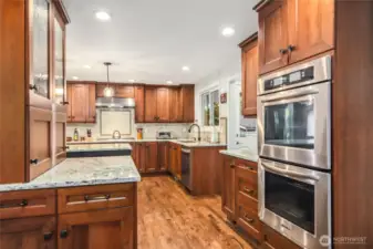 Tons of custom cabinet storage and double oven is a focal point of this stunning Chef's kitchen.