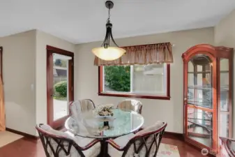 The kitchen offers a welcoming eating area with convenient access to the patio and backyard.