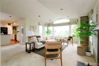 Upper level: living room with cathedral ceiling and antique fireplace