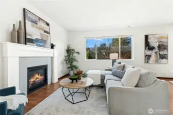 Gas fireplace with tons of natural light from oversized windows
