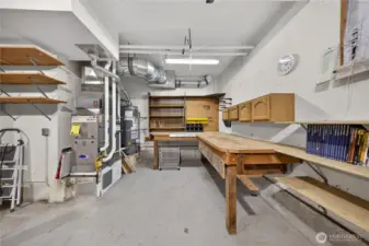 Great workspace in the garage with built in cabinets and work bench