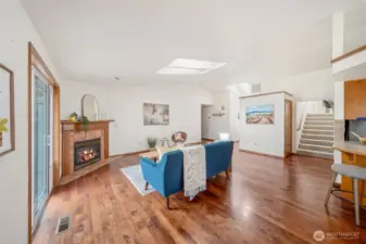 This angle from the eating area shows the stairs to the bonus room over the garage, and the hallway leading to the bedrooms.