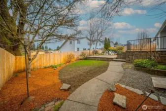 The well kept low maintenance yard continues around the side of the home.