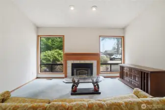 Living room with fireplace and front windows