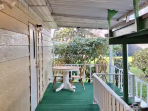 Great Covered deck for those rainy days.  Beautiful red Rhode's that give shade & privacy. Time to read a book, have a cup of coffee or have lunch. Summer is coming soon be time to have a cookout. Power is on the deck for a BBQ grill oR FOR EXTRA HANGIN LIGHTS for special occassions