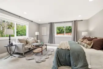 Comfortable primary with natural light and peaceful outlook