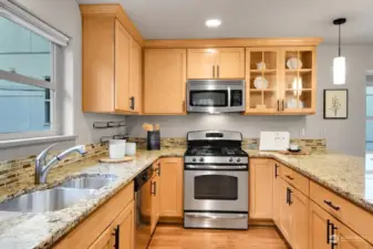 Stainless steel appliances, a gas stove, maple cabinets and great lighting make the chef happy.