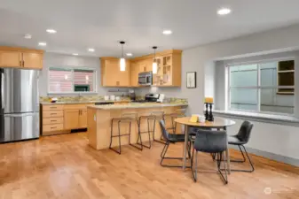 This open floor plan features a breakfast bar AND space for a dining table.