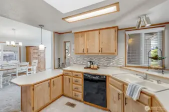 Kitchen has abundant cabinet and countertops, including a pantry next to fridge