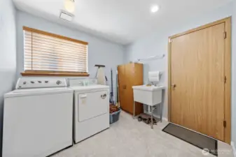 Laundry room with mud sink and large window.