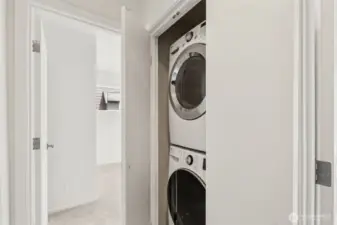 Conveniently located near the main bedrooms, the stackable washer and dryer offer efficient laundry access without sacrificing space or style.