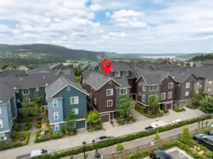 Closer view showcases the townhome’s clean lines, updated exterior, and attached garage—perfectly situated in a well-maintained, walkable neighborhood.
