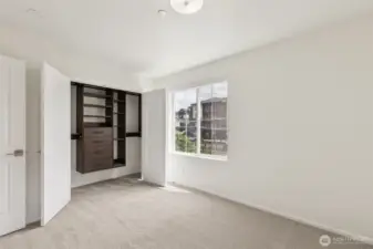 Custom built-in closet system in the primary suite offers smart storage with a clean, organized layout—combining function and luxury for everyday ease.