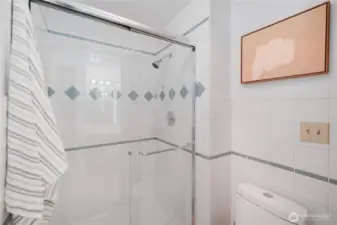 En-suite bathroom connected to the primary bedroom. Private shower and water closet with heat lamp and exhaust fan.