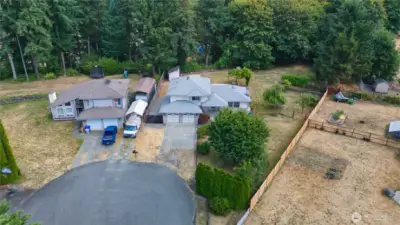 The property extends beyond the back fence and includes most of the trees behind the yard.