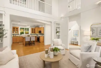 View from the living room to the kitchen, the upper corridor and the dining room to the right.