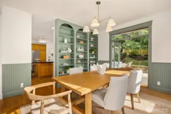 The dining room with recently built custom shelves an added wainscoting.